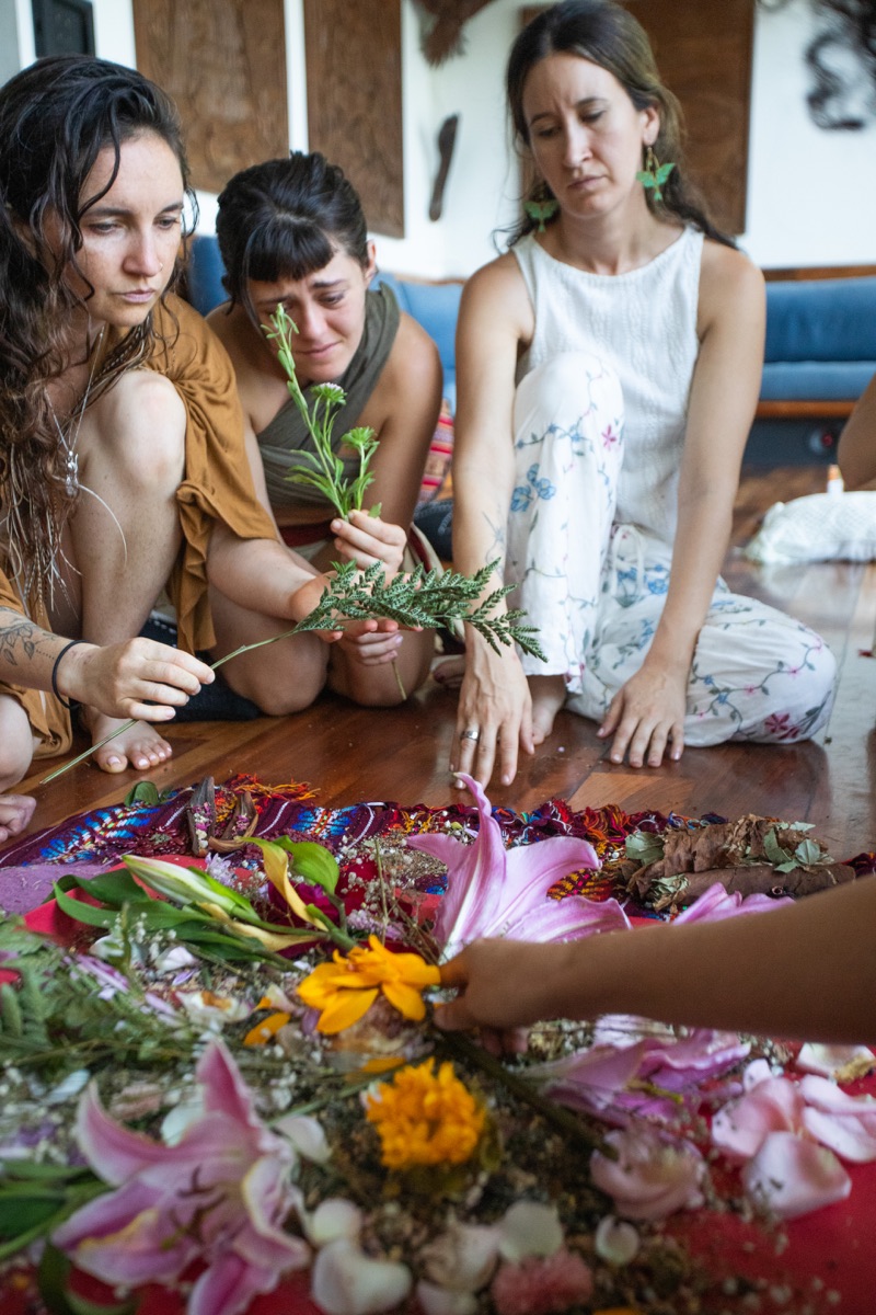 Women gathered together with flowers in a ceremony
