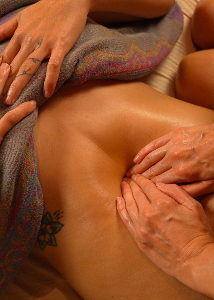 Hands performing traditional abdominal massage
