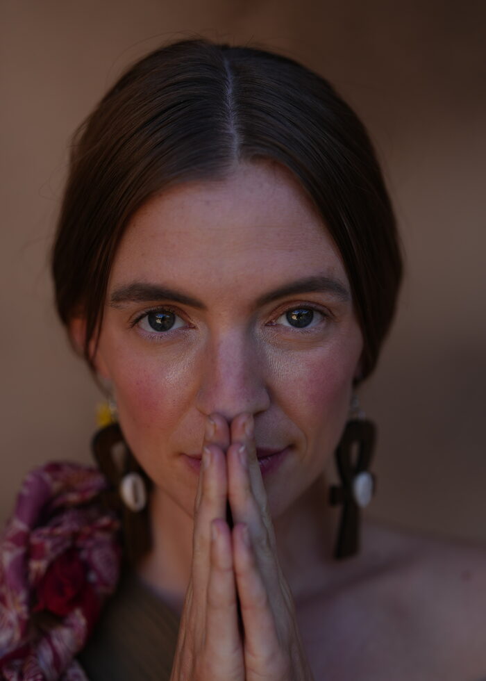 Woman with hand resting on her heart